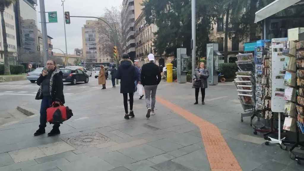 Dos jóvenes caminan por la Plaza de España de Mallorca, este pasado jueves.